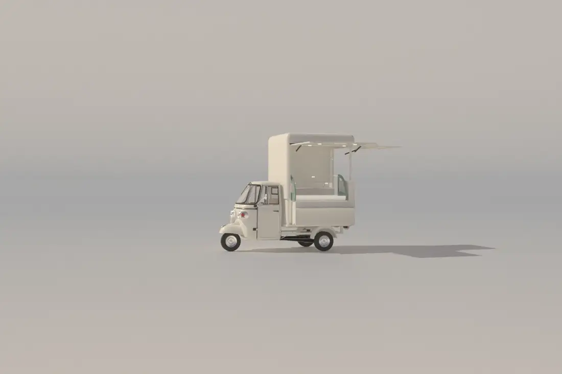 Triporteur électrique blanc, auvent relevé sur un comptoir de vente